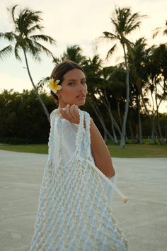 Handcrafted by artisans, the Talli Macrame Tote Bag is the perfect chic summer tote. Made from soft but sturdy 100% cotton in varying tones of cream and white, it features a braided shoulder strap and a removable satin liner bag. This open-knit tote is perfect for both beach days and evening strolls, offering versatile elegance. White Macrame Shoulder Bag For Everyday Use, Spring Natural Macrame Shoulder Bag, White Macrame Vacation Bag, Cream Crochet Tote Bag With Macrame, White Handwoven Beach Shoulder Bag, Summer White Crochet Bag With Braided Details, White Handwoven Shoulder Bag For Summer, White Woven Shoulder Beach Bag, Everyday White Crochet Bag With Braided Details