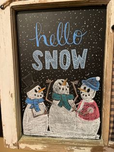 a chalk board with three snowmen on it and the words hello snow written in blue