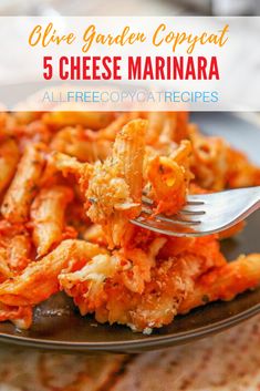 a fork is stuck into some food on a black plate with red sauce and parmesan cheese