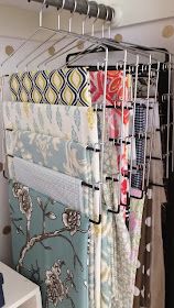 a rack with several different fabrics hanging on it