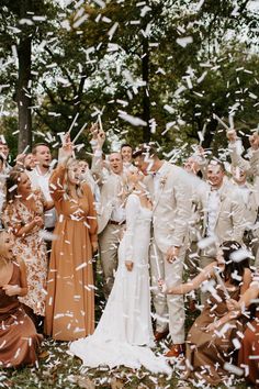 a group of people standing next to each other under confetti