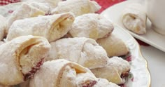 powdered sugar filled pastries on a plate