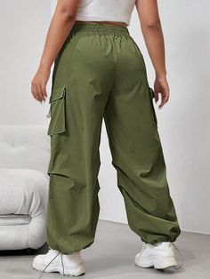 Embrace the utility trend with our Flap Side Pocket Drawstring Waist Loose Cargo Pants. These long-length pants combine practicality and style effortlessly. The loose fit and natural waistline provide all-day comfort, while the button details and flap side pockets add a touch of rugged charm. Made from durable woven fabric, these cargo pants are built to withstand daily wear and tear. Specifications: Details: Button, Pocket Waist Line: Natural Fit Type: Loose Type: Cargo Pants Length: Long Fabri Baggy Green Bottoms With Drawstring, Loosely Fitted Wide Leg Cargo Pants With Drawstring, Baggy Utility Harem Pants With Elastic Waistband, Solid Color Baggy Utility Sweatpants, Solid Baggy Utility Sweatpants, Utility Harem Pants With Cargo Pockets, Wide Leg Parachute Pants With Drawstring For Outdoor, Baggy Utility Bottoms With Elastic Waistband, Baggy Full-length Parachute Pants With Drawstring