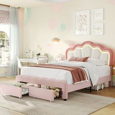 a bedroom with a pink bed and white furniture