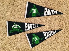 three green and white pennants with the words raven's football team on them