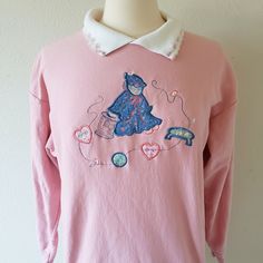 Adorable pink sweatshirt with sewing decal and hearts on the collar. Brand is Bobbie Brooks, and there is no size/fabric tag (it seems like a medium, and fabric does have some stretch to it) so please be sure to read the measurements below carefully. Please refer to the measurements listed below in order to determine the correct fit. Returns/exchanges are not accepted at this time. Feel free to message me if you have any questions. Pit to pit: 21 inches Length: 25 inches Sleeves: 17.5 inches Retro Pink Sweatshirt For Winter, Retro Pink Sweatshirt For Fall, Vintage Pink Long Sleeve Tops, Vintage Embroidered Long Sleeve Sweatshirt, Vintage Long-sleeved Embroidered Sweatshirt, Vintage Long Sleeve Sweater For Loungewear, Vintage Pink Sweatshirt For Winter, Pink Retro Cotton Sweatshirt, Pink Vintage Sweatshirt For Winter