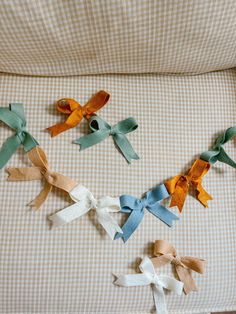 several different colored bows are tied together on the back of a baby's crib