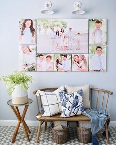 a bench with several pictures on the wall above it and two baskets under them next to a table