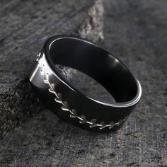 This is a USA made comfort fit 8mm wide Black Zirconium band with a flat profile. The black ring is carved with a Baseball stitching design that exposes the silver Zirconium below the many, many layers of blackened Zirconium. The two-tone sports ring has an inside comfort fit and is very strong and durable. This fantastic sports ring features a hand-completed polish finish by expert jewelry artisans! 8mm Wide Black Zirconium Ring Polish Finish Inside Comfort Fit Design Black Etched Rings For Anniversary, Anniversary Black Etched Rings, Baseball Ring, Zirconium Ring, Black Zirconium Ring, Baseball Stitching, Black Ring, Black Rings, The Black