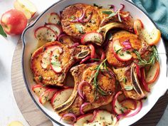 a white bowl filled with chicken, apples and onions