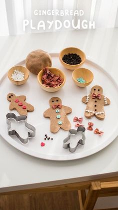 gingerbread playdough on a white plate with wooden spoons and small bowls