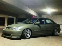 a green car parked in a parking garage