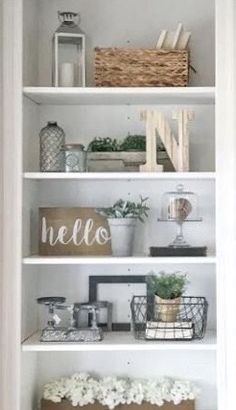 a white book shelf filled with lots of books and other items on top of it