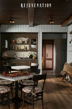 the dining room table is surrounded by chairs and other furniture in an old - fashioned kitchen