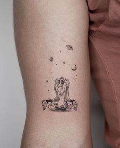 a woman's arm with a tattoo on it that has an image of a lion