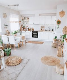 a living room filled with lots of furniture next to a kitchen and dining room table