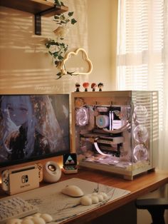 a desk with a computer, keyboard and mouse on it in front of a window