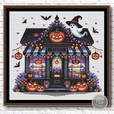 a cross stitch halloween house with pumpkins and jack - o'- lanternes