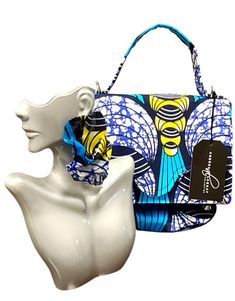 Introducing our latest addition to the Andrea Lashay Collection - a stunning handcrafted purse paired with matching earrings. This set features a vibrant blue, yellow, and black abstract print that exudes artistic flair and bold fashion. The purse, measuring 9 x 6 inches, is designed with a sturdy blue handle, making it a stylish statement piece for any fashion-forward individual. Matching Earrings: The accompanying earrings are designed to perfectly complement the purse, showcasing the same vibrant colors and patterns. These dangle-style earrings add a touch of elegance and complete the look effortlessly. Note from the Designer: As I embark on my journey into purse making, I want to share that while these purses are not yet perfected, they are crafted with love and a keen eye for style. E Trendy Blue Shoulder Bag For Gift, Trendy Blue Handmade Shoulder Bag, Chic Blue Shoulder Bag Gift, Chic Blue Shoulder Bag For Gift, Chic Handmade Blue Shoulder Bag, Artistic Blue Shoulder Bag For Travel, Artistic Handmade Blue Bags, Artistic Blue Bag As Gift, Artistic Blue Bag As A Gift