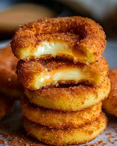 some donuts are stacked on top of each other and have cheese in the middle