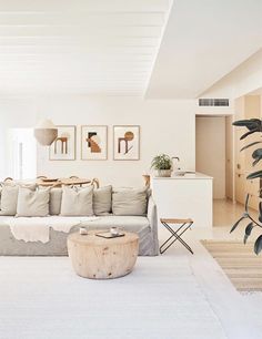 a living room filled with lots of furniture next to a white rug and wooden table