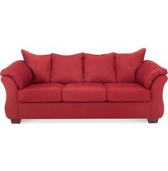 a red couch sitting on top of a white floor