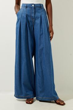 Feel Confident In Our Denim Trousers, Made With High Quality Denim Fabric, Featuring An Ultra Comfortable Wide Leg Fit, And Unique Pleated Details. Style Them With Block Heels Or Ankle Boots For A Look Perfect For Office Days Or Casual Days Out, Then Wear Them With Heeled Boots For An Evening Look. Tailored Chambray Denim Straight Leg Pleated Trousers High Quality Denim Fabric Statement Wide Leg Fit Formal Pleat Detailing Comfortable High Waistline Pocket Features Belt Loops Button Front Fasteni Dark Wash Cotton Trousers, Indigo Baggy Bottoms For Spring, Indigo Fitted Wide Leg Jeans, Fitted Wide Leg Indigo Jeans, Indigo Wide Leg Bottoms For Spring, Non-stretch Medium Wash Trousers, Baggy Denim Wide Leg Pants, Spring Indigo Wide Leg Bottoms, Relaxed Fit Medium Wash Denim Wide Leg Pants