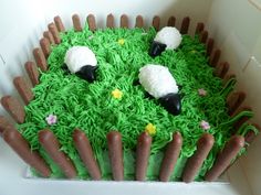 a cake made to look like grass with sheep on it