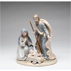 a figurine of the nativity scene with jesus and mary holding a staff