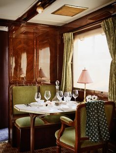 a dinning room table with wine glasses on it