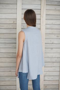 "Loose linen top / Linen blouse with gussets / Linen summer blouse / Sleeveless linen shirt / Linen maternity blouse / Ice blue Comfortable linen cloth hand made from washed linen fabric. The blouse is loose, flare, with two triangular shape insets in sides. You can choose from 16 colors. (The color palette you can find it in the end of listing). Details: - 100% pure Baltic linen; - medium weight linen; - color: ice blue - washed; - simply finished; - handmade; Size: model is wearing size M GENE Spring Linen Beach Vest, Flax Sleeveless Top For Spring, Spring Flax Sleeveless Top, Sleeveless Flax Tops For Spring, Spring Sleeveless Flax Tops, Spring Linen Sleeveless Blouse, Chic Linen Blouse For Layering, Sleeveless Linen Summer Blouse, Spring Sleeveless Linen Blouse