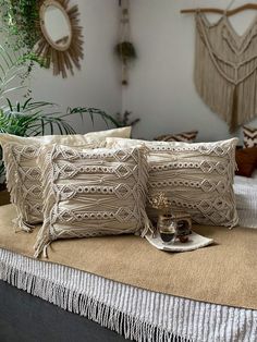 two decorative pillows sitting on top of a bed