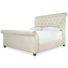 a white bed with tufted headboard and foot board