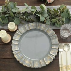 a table setting with plates, silverware and flowers