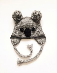 a crocheted hat with a koala bear on it's face and ears