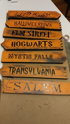 several wooden signs are stacked on top of each other in order to spell out their names