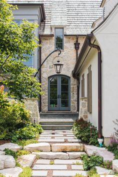 a stone walkway leads up to the front door of a house