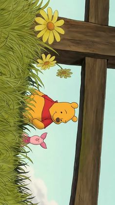 winnie the pooh hanging from a cross with daisies in the air behind it