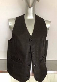 "Simple dark brown leather vest, 2 patch pockets, 4 snap front closure. Dark brown good quality leather. Great attire for musicians, stage performance etc.etc.. Great details on this piece would be the 9\" long rear darts, and the same length darts in the front, assuring a proper fitted form. I believe this is a males waistcoat/vest as it snaps close on the right side which I believe is the general rule of thumb as to whether it male or female clothing but who really cares, a woman could easily Who Really Cares, Brown Leather Vest, Handmade Vest, Kids Vest, Buckles Fashion, Female Clothing, Stage Performance, Vest Outfits, Leather Vest