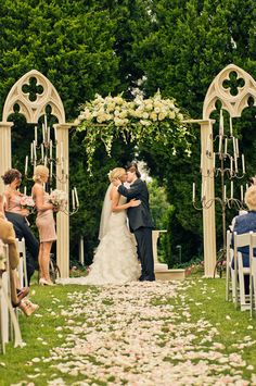 a bride and groom walking down the aisle