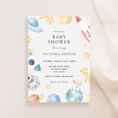 a baby shower is shown with watercolor planets and stars on the back of it