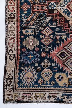 an old rug with many different designs on it