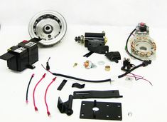 an assortment of parts for a vehicle on a white surface, including the motor and gear