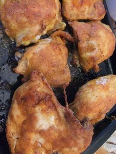 several pieces of chicken cooking in a frying pan