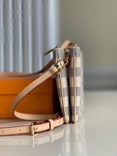 This summery version of the Double Zip Pochette comes in Damier Azur canvas with a removable strap in Louis Vuitton's emblematic natural cowhide leather. This versatile pouch features two secure zipped pockets with an open pocket in between. It is finished with a natural leather label embossed with the House signature. Detailed Features 20 x 12.5 x 3 cm (Length x height x width ) Damier Azur coated canvas and natural cowhide leather Natural cowhide-leather trim Microfiber lining Gold-color hardw Louis Vuitton Three Piece Pochette, Gold Ounce, Leather Label, Vuitton Bag, Natural Leather, Cowhide Leather, Leather Trims, Bag Sale, Inside Pocket