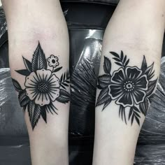 two black and white flower tattoos on both legs