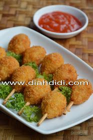 small appetizers on skewers with ketchup are served on a plate