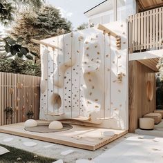 a wooden structure with holes in the middle and white paint on it's walls