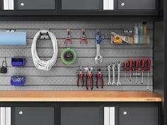 an organized garage with lots of tools hanging on the wall and cabinets in front of it