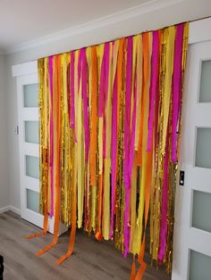 the room is decorated with orange, pink and yellow streamers